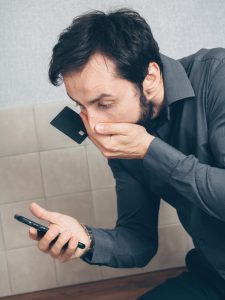 man person with a smartphone discovering a scam