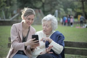 cheerful senior mother and adult daughter using smartphone together. What is a Pension Scheme and How Does It Work?